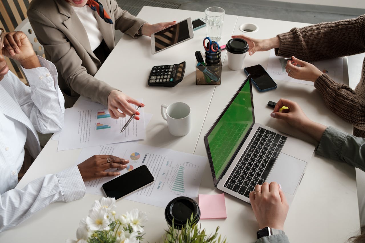 Co-workers working collaboratively over a shared work desk