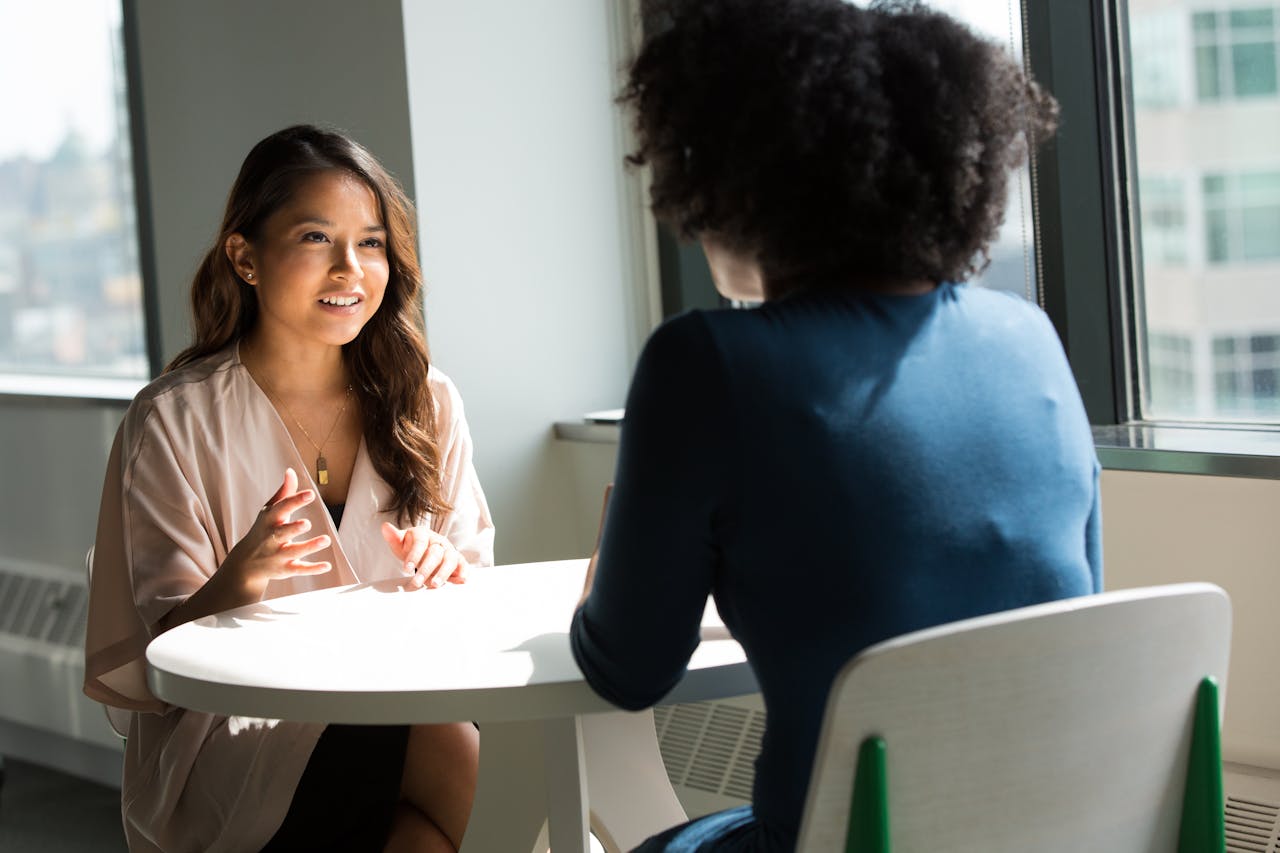 Two individuals talking during a meeting or appointment