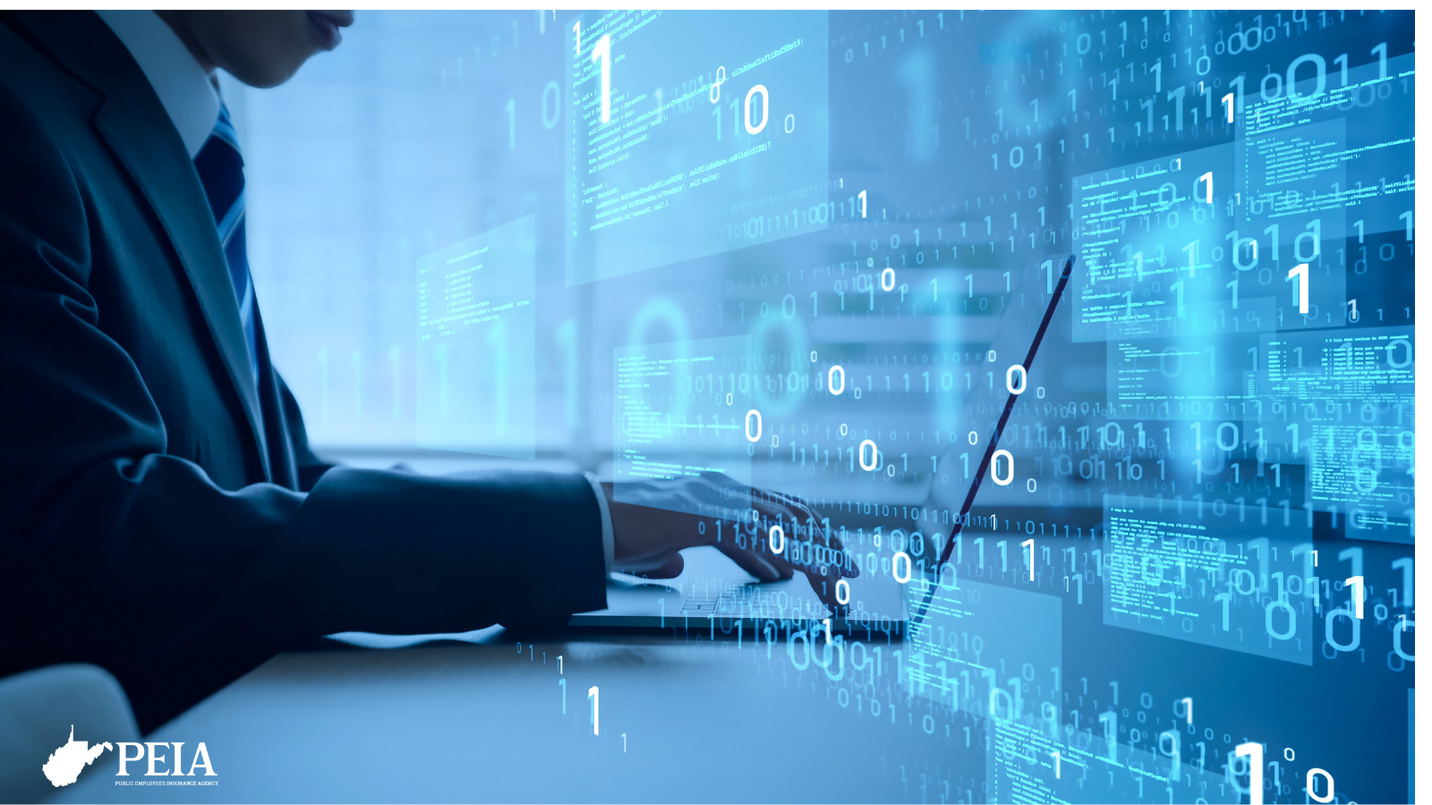 blue image of a man at a computer